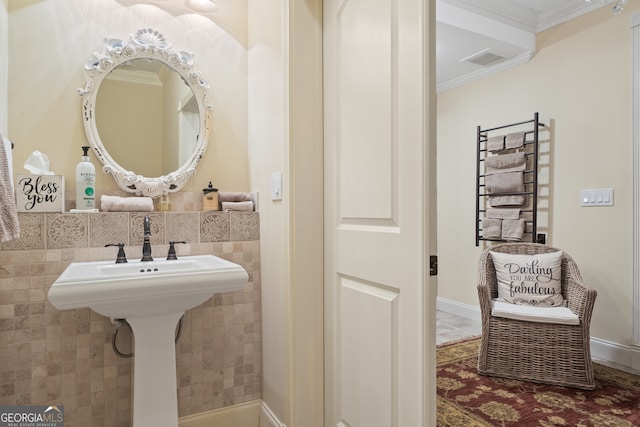 bathroom featuring ornamental molding and tile walls