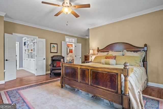 bedroom featuring crown molding, wood-type flooring, and ceiling fan