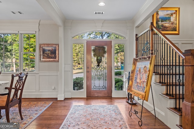 foyer featuring crown molding and wood-type flooring