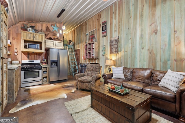 living room with wood walls, lofted ceiling, and concrete floors