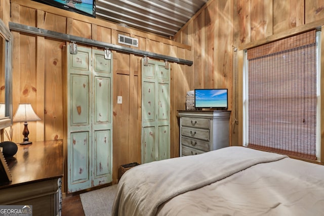 bedroom with wooden walls