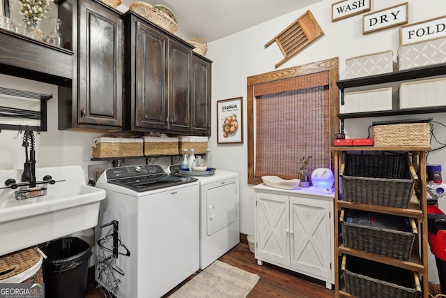 washroom featuring cabinets, washer and dryer, and dark hardwood / wood-style floors