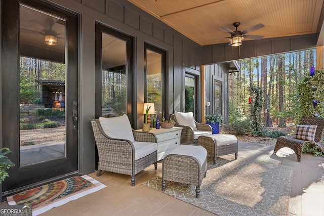 sunroom with ceiling fan and wood ceiling