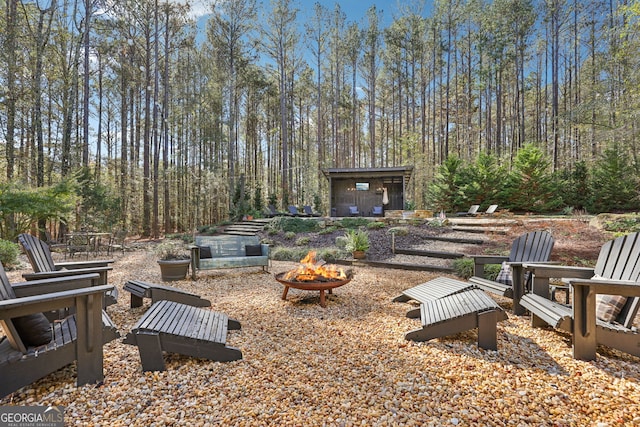 view of yard with an outdoor fire pit