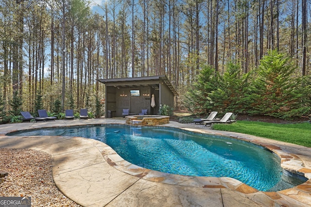 view of swimming pool featuring an in ground hot tub, a patio, and an outdoor structure