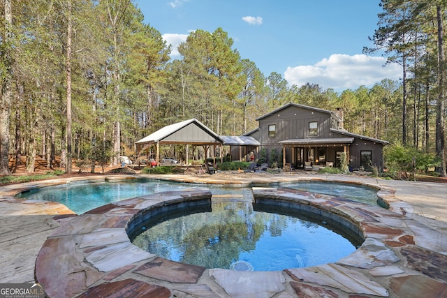 view of pool with a gazebo and an in ground hot tub