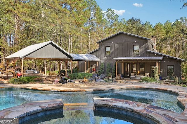 view of pool with an in ground hot tub and a patio