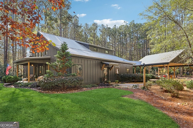 rear view of property with a sunroom and a yard