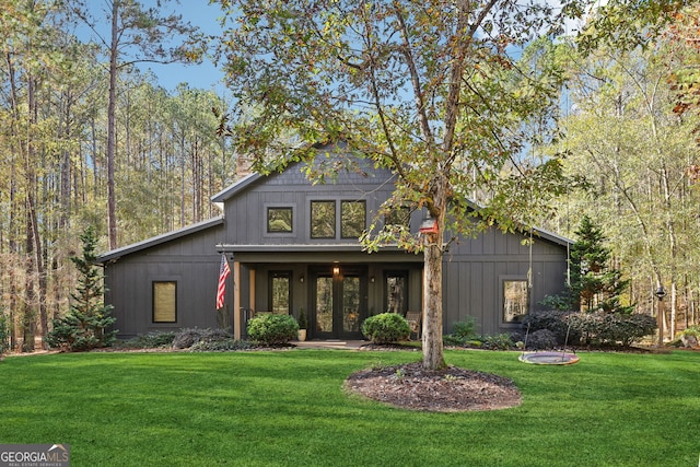 view of front of house with a front yard and french doors