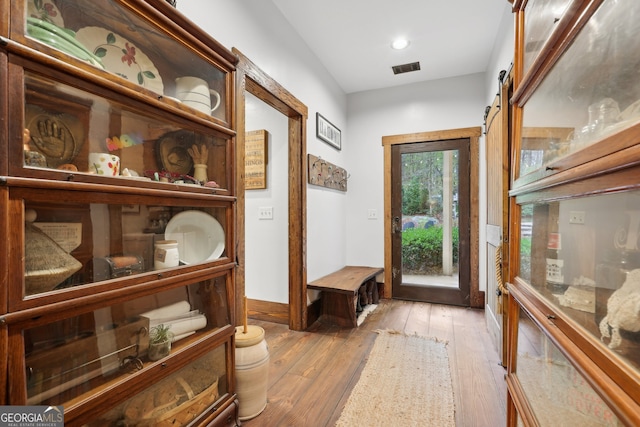 entryway with a barn door and light wood-type flooring