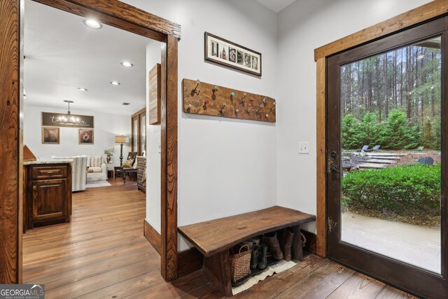 interior space with light wood-type flooring and an inviting chandelier