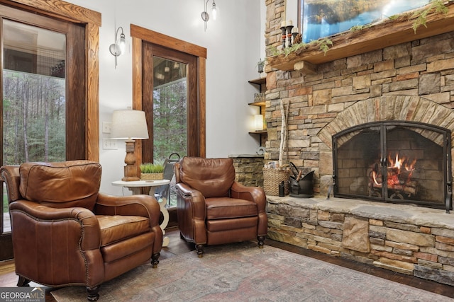 sitting room featuring hardwood / wood-style floors, a fireplace, and a wealth of natural light