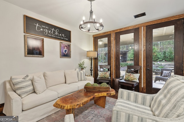 living room with an inviting chandelier and hardwood / wood-style flooring