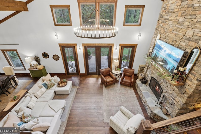 living room with beamed ceiling, dark hardwood / wood-style floors, high vaulted ceiling, and plenty of natural light