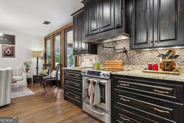 kitchen featuring decorative backsplash, stainless steel electric range oven, light stone countertops, and dark hardwood / wood-style floors