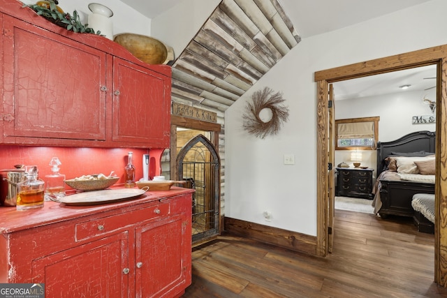 kitchen featuring dark hardwood / wood-style floors and vaulted ceiling