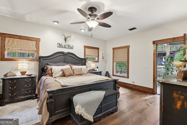 bedroom featuring access to outside, ceiling fan, and dark hardwood / wood-style flooring