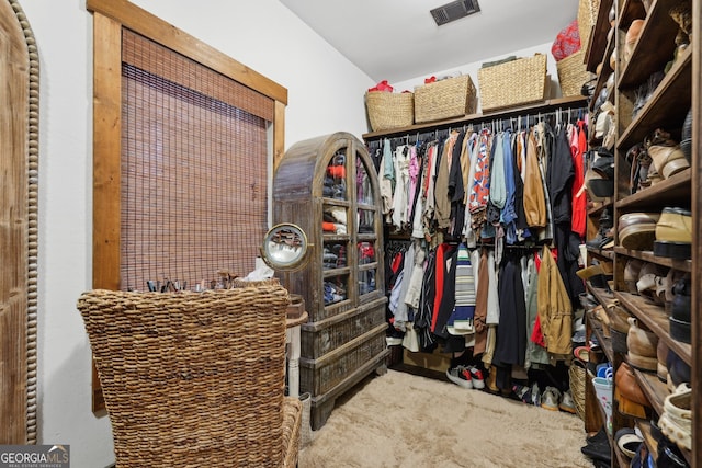 walk in closet featuring carpet