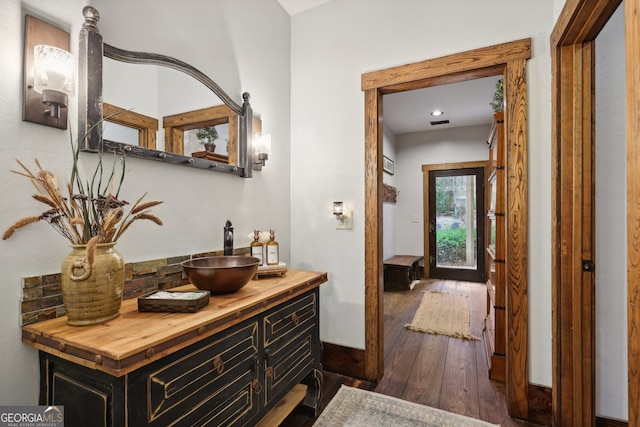 hallway with sink and dark wood-type flooring