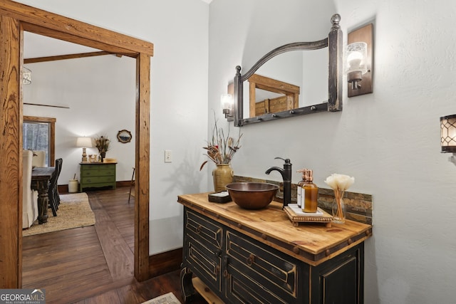 bathroom with hardwood / wood-style flooring and vanity