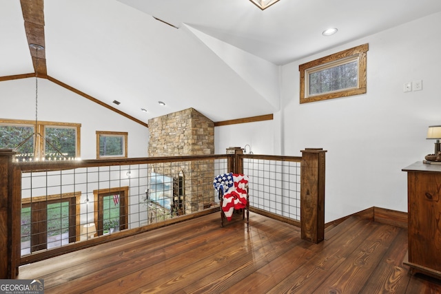 hall featuring beamed ceiling, high vaulted ceiling, and dark wood-type flooring