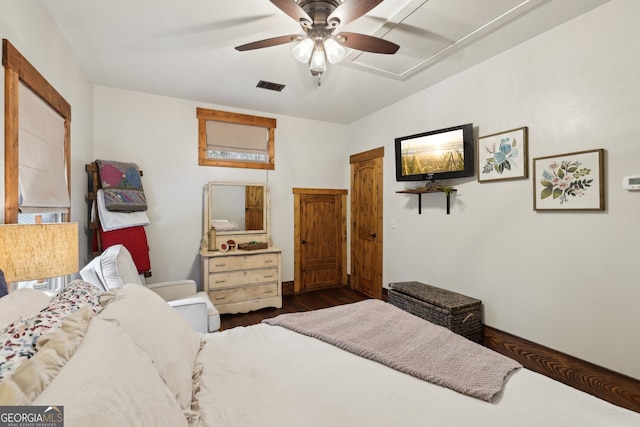 bedroom with ceiling fan and dark hardwood / wood-style floors