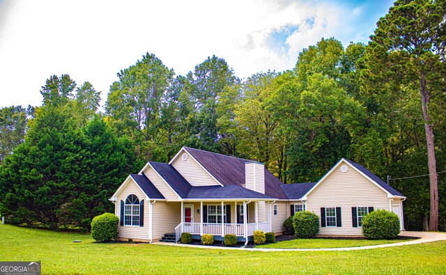 view of front of house with a porch and a front lawn