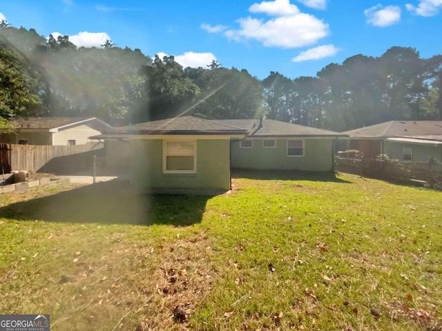 rear view of property featuring a yard and a patio