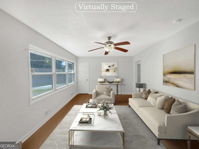 living room featuring a textured ceiling, dark hardwood / wood-style floors, and ceiling fan