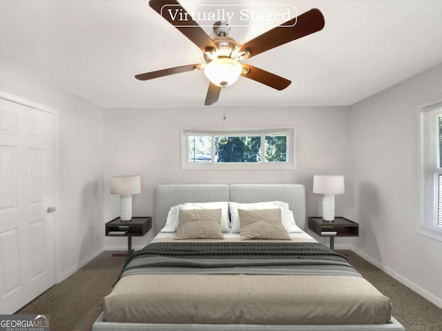 carpeted bedroom featuring multiple windows and ceiling fan