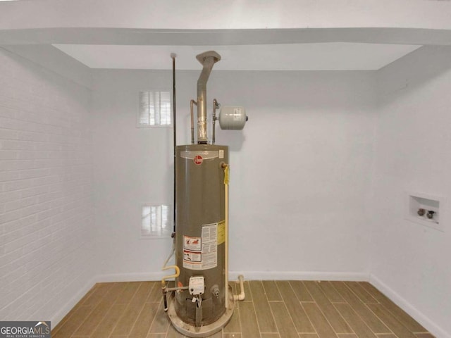 utility room featuring water heater