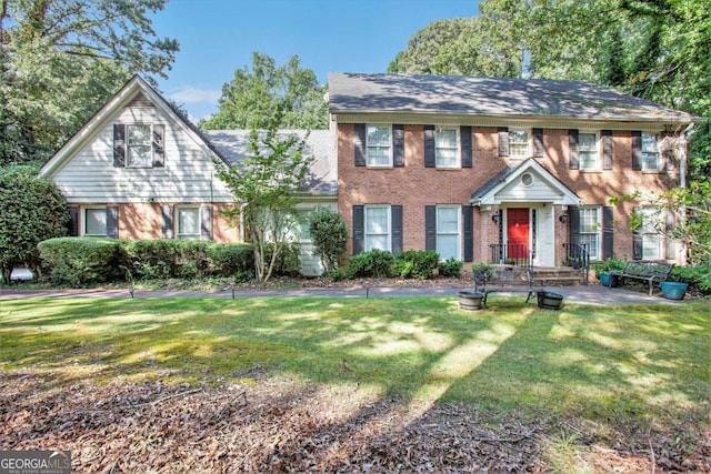 colonial inspired home with a front yard