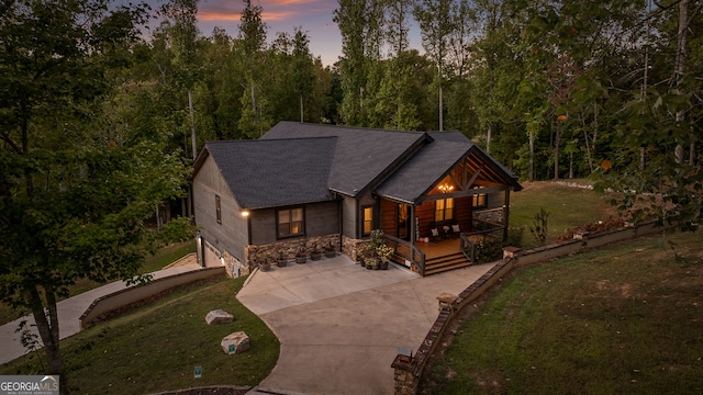 log home featuring a lawn and a porch