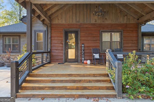 view of exterior entry with a porch