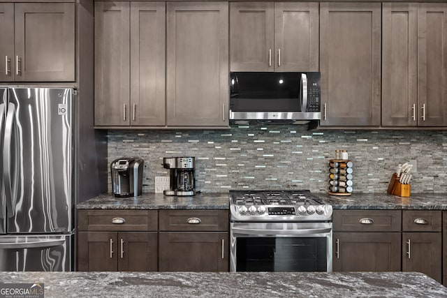 kitchen featuring decorative backsplash, dark stone countertops, dark brown cabinets, and stainless steel appliances