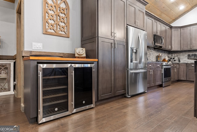 kitchen with appliances with stainless steel finishes, wood ceiling, dark wood-type flooring, lofted ceiling, and beverage cooler