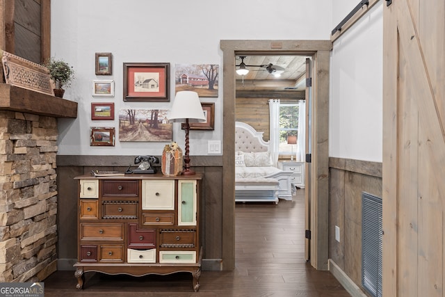 interior space featuring dark wood-type flooring and a barn door