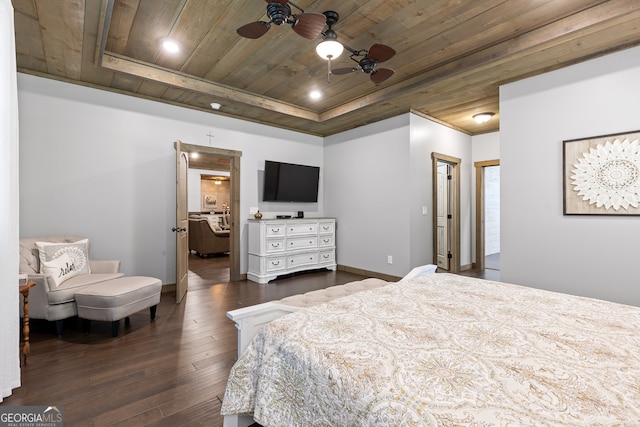 bedroom featuring wood ceiling, a tray ceiling, ceiling fan, and dark hardwood / wood-style flooring