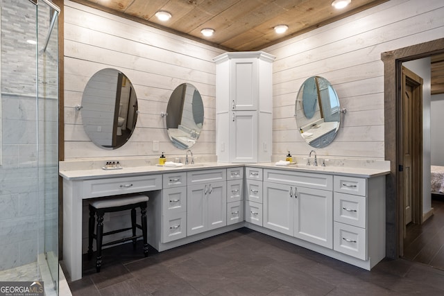 bathroom with wood ceiling, wood walls, and vanity