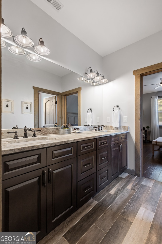 bathroom featuring wood-type flooring, vanity, and ceiling fan