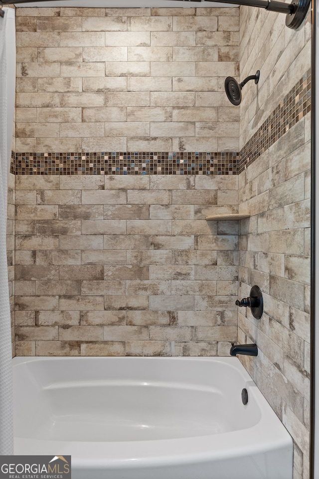 bathroom with shower / bath combo with shower curtain