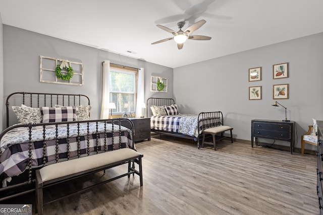 bedroom with wood-type flooring and ceiling fan