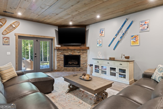 living room featuring wooden ceiling, a fireplace, light wood-type flooring, and french doors