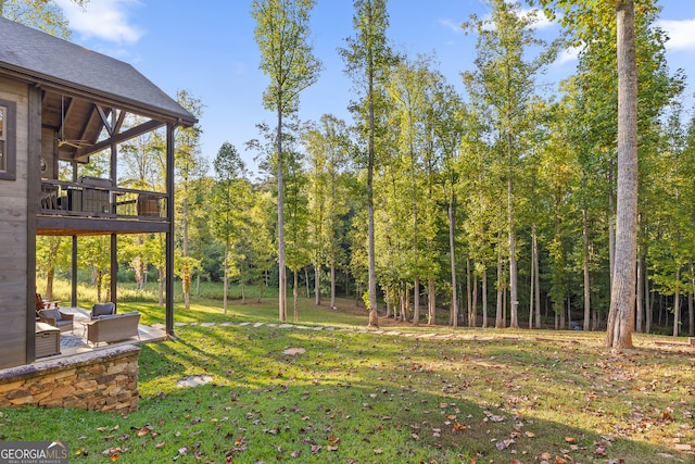 view of yard featuring a patio and an outdoor living space with a fire pit