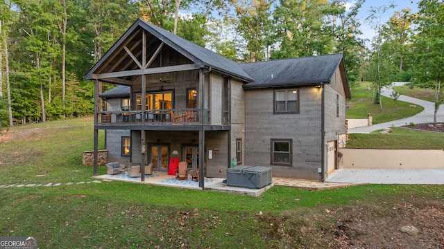 back of house featuring a patio, a yard, a balcony, and ceiling fan