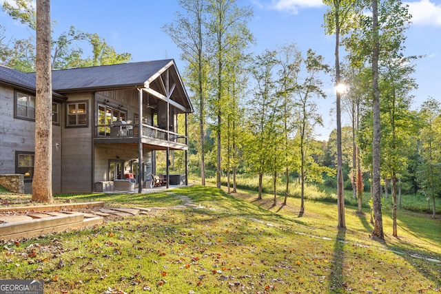 view of yard with a balcony