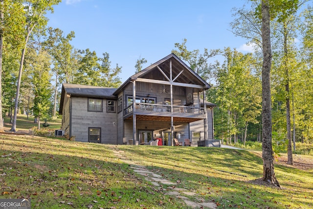 back of property featuring a yard, central AC, and a wooden deck