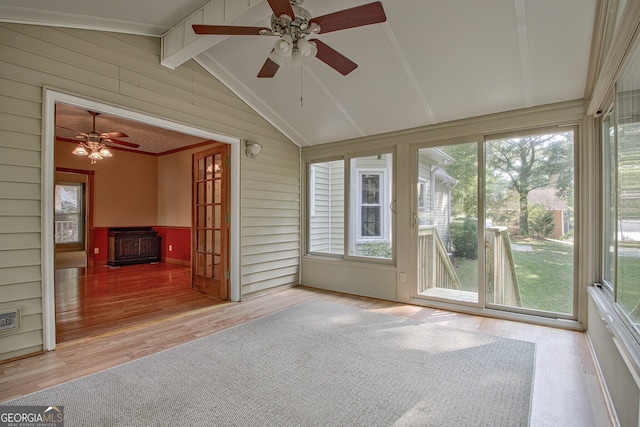 unfurnished sunroom with lofted ceiling with beams and ceiling fan