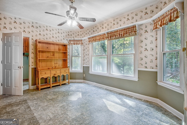 unfurnished bedroom featuring a textured ceiling, crown molding, and ceiling fan