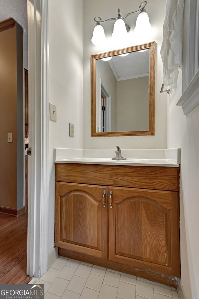 bathroom featuring crown molding, vanity, and hardwood / wood-style flooring